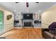 Living room with ceiling fan, brick fireplace, built-in shelving, and natural light at 155 Grandview Trce, Fayetteville, GA 30215