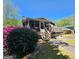 Home featuring a back deck with wooden stairs, surrounded by mature trees and landscaping at 4457 Huntshire Dr, Stone Mountain, GA 30083