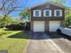 Traditional home featuring a well-manicured lawn and a two-car garage, showcasing suburban living at 4457 Huntshire Dr, Stone Mountain, GA 30083