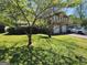 This house features a neat front lawn, mature trees, and an attached two-car garage at 4457 Huntshire Dr, Stone Mountain, GA 30083