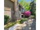 Back exterior view showcases brick chimney, back porch, and manicured landscaping around the home at 4457 Huntshire Dr, Stone Mountain, GA 30083
