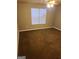 An empty bedroom features neutral-colored walls, carpet and ceiling fan with a bright window at 807 Boston Cmn, Atlanta, GA 30349