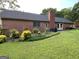 A well-maintained backyard highlights the home's brick exterior, mature landscaping, and natural light at 109 Old Virginia Cir, Jonesboro, GA 30236