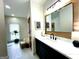Updated bathroom featuring a large mirror and vanity with an accent rug in the tub area at 109 Old Virginia Cir, Jonesboro, GA 30236
