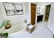 Bright bathroom featuring a soaking tub with decor, tiled floor, and spacious layout at 109 Old Virginia Cir, Jonesboro, GA 30236