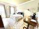 This light and airy bedroom boasts natural light, stylish accents, and hardwood floors at 109 Old Virginia Cir, Jonesboro, GA 30236