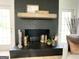Close-up of a black brick fireplace with a wooden mantel and decorative accents at 109 Old Virginia Cir, Jonesboro, GA 30236