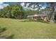 Lush front lawn of a single-story brick home with covered front porch and mature landscaping at 109 Old Virginia Cir, Jonesboro, GA 30236