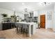 Modern kitchen with white cabinets, island seating, stainless steel appliances, and hardwood floors at 109 Old Virginia Cir, Jonesboro, GA 30236