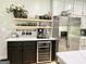 Open kitchen featuring modern stainless steel appliances, floating shelves, and wine cooler for entertaining at 109 Old Virginia Cir, Jonesboro, GA 30236