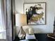 Living room decor, featuring a lamp, abstract art, and curated accessories on a dark cabinet at 109 Old Virginia Cir, Jonesboro, GA 30236