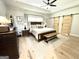 A spacious main bedroom offers an inviting view of comfort with an accent rug and barn doors at 109 Old Virginia Cir, Jonesboro, GA 30236