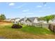 Backyard featuring a well-maintained lawn, mature landscaping, and a wooden fence for privacy at 12 Connie Trl, Grantville, GA 30220