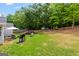 Wide shot of the expansive backyard featuring a swing and table set, and plenty of trees at 12 Connie Trl, Grantville, GA 30220