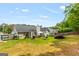 Spacious backyard featuring a well-maintained lawn, patio furniture, grill, and mature landscaping at 12 Connie Trl, Grantville, GA 30220
