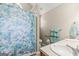 Bathroom featuring a white sink vanity, handicap bars, and a blue patterned shower curtain at 12 Connie Trl, Grantville, GA 30220