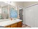 Bright bathroom with a white vanity and mirror, and an adjacent linen closet at 12 Connie Trl, Grantville, GA 30220