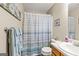 Clean bathroom featuring a white toilet, tub, and sink with a striped shower curtain at 12 Connie Trl, Grantville, GA 30220