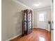 Entryway with hardwood flooring, display cabinet, and a white front door with decorative window panes at 12 Connie Trl, Grantville, GA 30220
