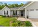 Close-up of home's front entrance featuring decorative landscaping, dark shutters, and inviting welcome sign at 12 Connie Trl, Grantville, GA 30220