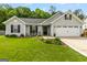 Beautiful gray home with a well-manicured lawn, dark shutters, and a 'Welcome' sign on the front porch at 12 Connie Trl, Grantville, GA 30220