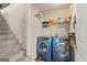 Laundry room with side by side washer and dryer units plus shelving for laundry supplies at 12 Connie Trl, Grantville, GA 30220