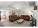 Spacious living room with a decorative ceiling, fireplace, carpeted flooring, and comfortable leather seating at 12 Connie Trl, Grantville, GA 30220