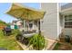 Cozy backyard patio area with a table, chairs, grill, and umbrella, perfect for outdoor dining at 12 Connie Trl, Grantville, GA 30220