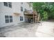 Exterior view of the home with a deck, patio, and backyard surrounded by lush greenery at 105 Kellens Ct, Fayetteville, GA 30215
