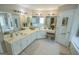 Large primary bathroom featuring double sinks, white vanity, and walk-in closet at 105 Kellens Ct, Fayetteville, GA 30215