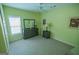Cozy bedroom with carpet, bright green walls, white trim, and a window letting in natural light at 105 Kellens Ct, Fayetteville, GA 30215