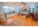Expansive bedroom with hardwood floors, coffered ceiling, and adjacent seating area at 105 Kellens Ct, Fayetteville, GA 30215