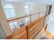 Wide hardwood steps lead to the second-floor view to the living room below at 105 Kellens Ct, Fayetteville, GA 30215