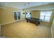 Game room has tile flooring, a black covered pool table with hanging lamps, and a window at 105 Kellens Ct, Fayetteville, GA 30215