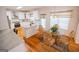 Eat-in kitchen with white cabinets, stainless steel appliances, granite counters and hardwood floors with a cozy breakfast nook at 105 Kellens Ct, Fayetteville, GA 30215