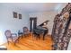 Living room featuring a black baby grand piano and elegant decor, creating a refined and inviting space at 105 Kellens Ct, Fayetteville, GA 30215