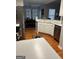 Bright kitchen with white cabinets, stainless steel appliances, hardwood floors and ample counter space at 1129 River Green Ct, Mcdonough, GA 30252
