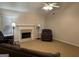 Cozy living room featuring a fireplace, carpeted floor, ceiling fan, and natural light from the window at 1129 River Green Ct, Mcdonough, GA 30252