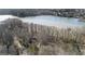 A home surrounded by trees with lake view in the background at 84 Contour Dr, Stockbridge, GA 30281