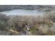 A home surrounded by trees with lake view in the background at 84 Contour Dr, Stockbridge, GA 30281