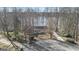 Aerial view of the house, surrounded by trees, with a circle driveway at 84 Contour Dr, Stockbridge, GA 30281