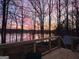 A sunset view from a wooden deck at 84 Contour Dr, Stockbridge, GA 30281