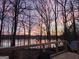 A sunset view from a wooden deck at 84 Contour Dr, Stockbridge, GA 30281