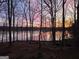 A sunset view of a lake at 84 Contour Dr, Stockbridge, GA 30281