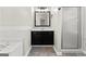 Bathroom featuring a vanity, large mirror and a glass enclosed shower at 84 Contour Dr, Stockbridge, GA 30281