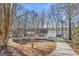 Single story home featuring mature trees, front porch and landscaping at 84 Contour Dr, Stockbridge, GA 30281