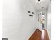 Bright entry featuring wood floors, shiplap accent wall and decorative shelves at 84 Contour Dr, Stockbridge, GA 30281