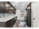 Modern kitchen with stainless steel appliances, dark wood cabinets, and tiled backsplash at 84 Contour Dr, Stockbridge, GA 30281
