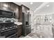 Modern kitchen with stainless steel appliances, dark wood cabinets, and tiled backsplash at 84 Contour Dr, Stockbridge, GA 30281