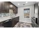Modern kitchen with stainless steel appliances, dark wood cabinets, and tiled backsplash at 84 Contour Dr, Stockbridge, GA 30281